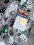 Bin of assorted mystery sobriety coins and AA recovery medallions